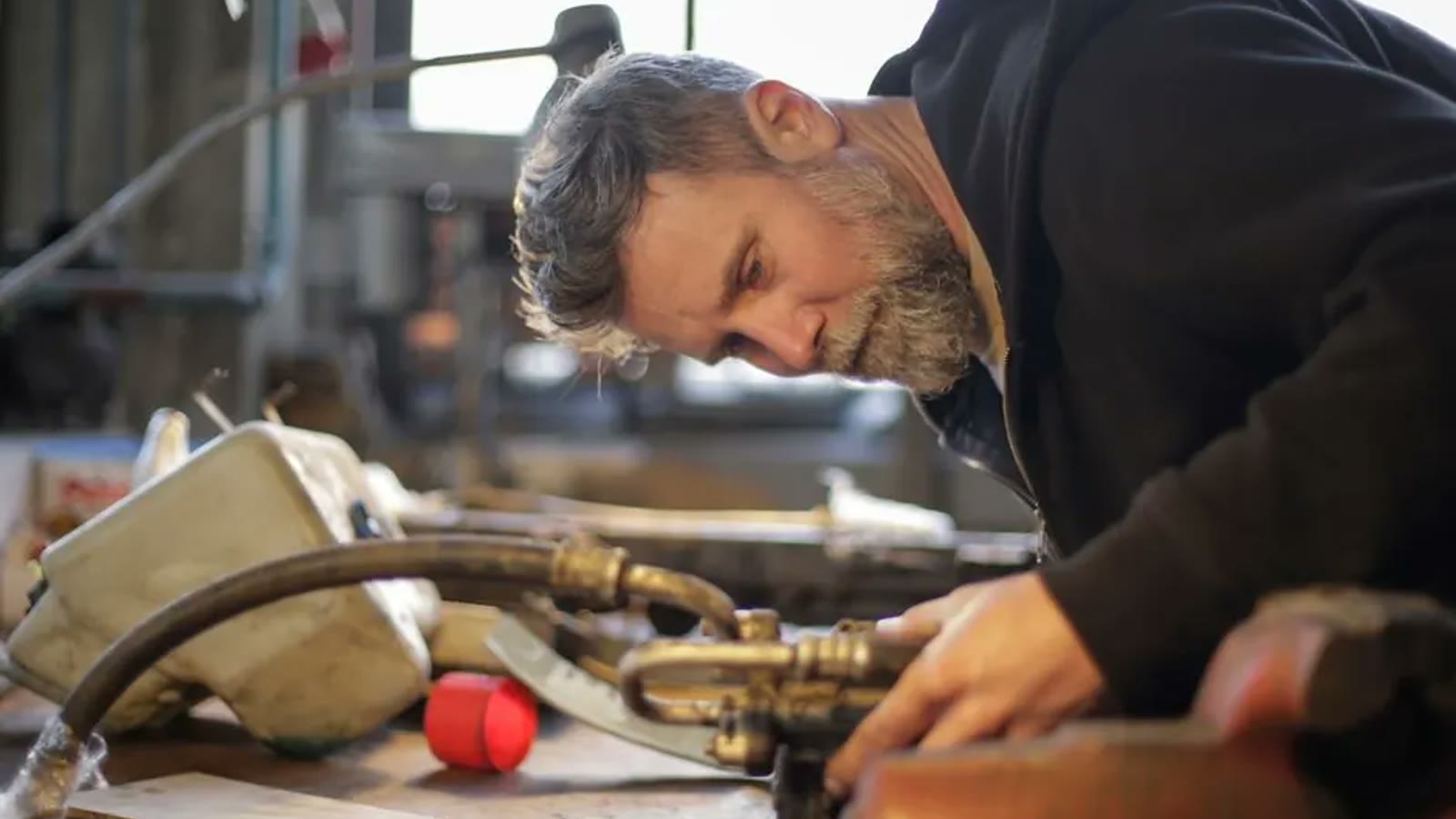 Technician examining a disassembled plumbing fixture